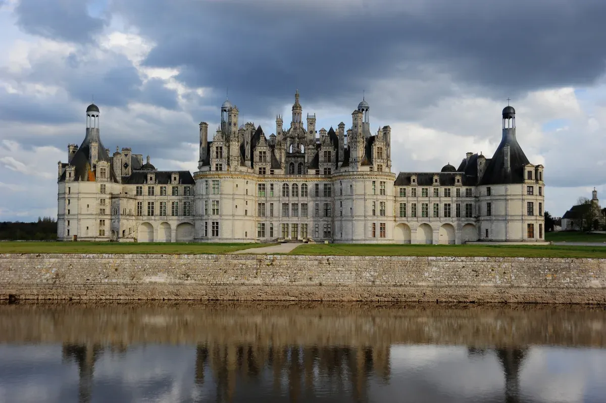 The Château de Chambord Renaissance facade seen from the water on a Loire Valley castles tour