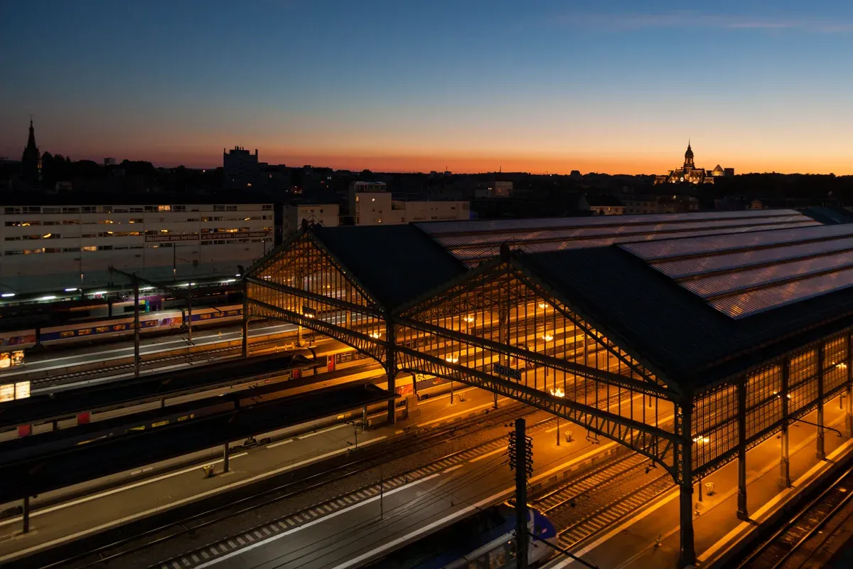 Tours station train sheds at dusk, the rail hub for a Loire Valley castles tour from Paris